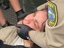 Woman, 47, arrested over KFC incident filmed telling cops 'I can't breathe' as she was booked into jail... moments later she was dead