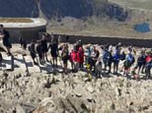 'There's a queue!': Moment hikers clash at top of Mount Snowdon as huge crowds wait in line to reach summit