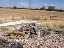Abandoned vehicles and rubbish piles left behind by travellers who set up illegal camp in 'land grab' on green belt site near village over Easter bank holiday weekend