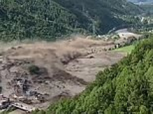 An entire settlement destroyed in just seconds: Video shows huge torrent of floodwater bulldoze through buildings in Nepal as people try to outrun certain death