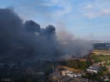 Huge blaze breaks out in London as 125 firefighters rush to battle flames and smoke billows over the capital