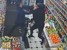 Moment shopper desperately grapples with gunman in London corner shop as he's targeted in 'underworld shooting'
