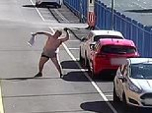 Moment shirtless man fails three times to throw £12,000 parcel of drugs and phone into prison - as he is jailed for nearly four years