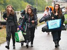 Thousands of revellers brave the rain as they set up camp at Reading festival ahead of Bank Holiday weekend