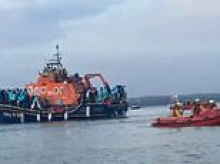 RNLI boats carrying 140 migrants were denied entry to TWO ports before they landed at docks near Portsmouth and met by hundreds of protesters