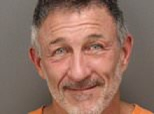 Local millionaire nuisance flashes a smile as he's arrested AGAIN after being jailed for building illegal $1M pickleball court at his mansion