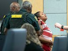 Suspected murderer is dragged out of courtroom kicking and screaming as she insists she shot boyfriend dead in self-defense