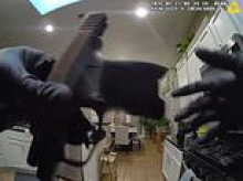 Family left stunned after little girl, 8, walks into kitchen, grabs handgun off counter and shoots herself in both legs... as older cousin is arrested