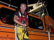 RNLI volunteer says 'I'm not a traitor' after being wrongly named as helping small boat migrants ashore - as protesters demonstrate outside charity's HQ