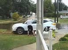 Shocking moment entitled driver is screamed at by elderly homeowner after she drove on his lawn during torrential downpour