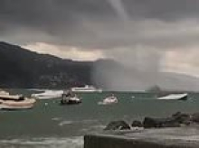 Moment giant water spout bears down on tourist boat in Italy as country is lashed with deadly flash floods and storms
