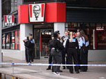Boy, 14, was among three teenagers stabbed in KFC 'machete gang fight' - as youths are questioned over attempted murder