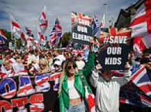 Hundreds of anti-migrant protesters march in Portsmouth as police warn them not to cover their faces after vowing to make more arrests