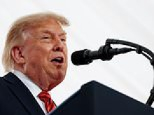 Trump gets a huge laugh as he reveals why wife Melania refused to join him on trip to Ireland... but controversial 'human printer' aide Natalie Harp is right by his side