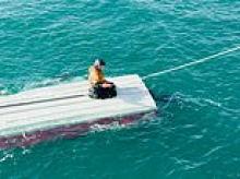 Boy, 15, is rescued after clinging on to capsized boat for two days in Alaska's Bering Sea after his brother and cousin drowned
