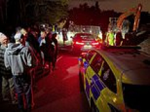 Travellers whose bank holiday 'land grab' was foiled by residents are blocked from returning after a High Court injunction is extended