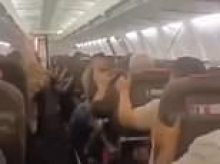Moment Boeing 737's cabin roof collapses on to screaming passengers as tyre bursts and shuddering aircraft suffers engine damage in Iran