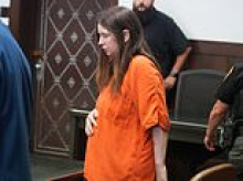 Ohio house of horrors mom-of-16 pleads not guilty to child abuse charges as she cradles stomach in court - but lawyer refuses to say if she's pregnant again
