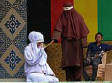 Lovers are flogged 100 times each for adultery with girlfriend begging for mercy then collapsing in pain during brutal Sharia caning in Indonesia