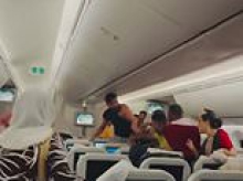 Two men throw punches at each other during flight from Bangladesh to London, with one man losing his T-shirt during the brawl