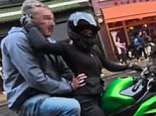 Moment 'inappropriate old man' jumps on primary school worker's motorbike and grabs her hips in front of his laughing pals
