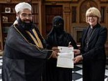 Archbishop of Canterbury is accused of condoning repression of Muslim women after she is pictured with covered wife of Islamic cleric who honoured Osama bin Laden