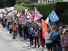 Protesters march in town after former military base is turned into asylum camp housing 540 male migrants