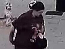 One-year-old boy is rushed to hospital after 'dog lunged at pushchair and attacked him': Police release CCTV of woman