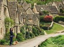 Controversial homeowners on England's prettiest street are forced into demolition works after claims they were turning historic cottage into 'monstrosity'
