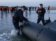 French police slash migrant dinghy on beach as more asylum seekers land in Dover after crossing the Channel