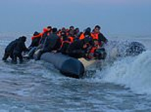 Another packed migrant mega-dinghy heads to Britain from Normandy - with a full French safety escort