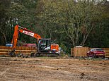 Travellers are ordered to leave illegal site opposite Britain's biggest nuclear weapons factory after building 13 static homes