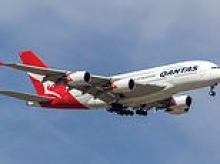 Qantas passenger allegedly tried to open plane door mid-flight after abusing traveller and cabin crew - before armed cops dragged him off at Perth Airport