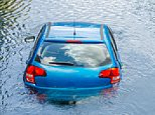 Mother accused of trying to drown her three young children by driving their car into a lake to remain behind bars