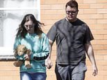 Gutwrenching moment grieving mum clutches her child's teddy bear after baby daughter's 'suspicious' death - as mystery man, 23, is quizzed by homicide squad in murder probe