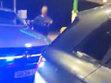 Danny Tommo is arrested at a petrol station for criminal damage after filming himself slashing Channel dinghy with rescuer on board