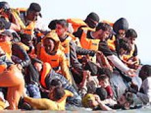 Moment migrant abandons child before scrambling onto dinghy - as record 781 cross Channel on small boats in a single day