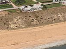 Millionaire bought Nantucket home atop cliff for pittance despite warnings it would likely crumble into ocean... but he now appears to have beaten nature in spectacular style