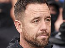 'Danny Tommo' is charged with criminal damage - as hundreds of black-clad supporters gather outside police station in protest at his arrest