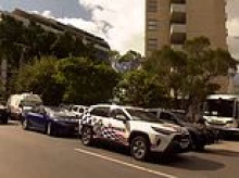 Woman is found dead inside a bin outside an apartment block