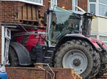 Gangland thug who used stolen tractor as a battering ram and smashed it into rival's home is jailed for seven years