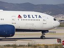 Four people are rushed to hospital after packed Delta Airlines jet was forced to make emergency landing over smoke in cabin