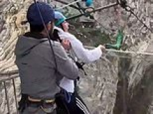 Moment terrified female tourist is forced into 260ft canyon leap by staff who kick her legs in front of laughing husband - as video sparks probe