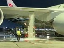 Moment airport worker causes huge leak after driving off with fuel hose still attached to jumbo jet