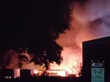 Huge fire erupts on industrial estate with 'explosions heard' and trains cancelled