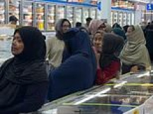 Customers at Asian supermarket in east London form separate male and female queues as they wait in line for discounted cooking oil