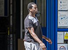 'Fugitive' asylum seeker wanted for trying to headbutt, bite and spit at female police officers found in prison after separate arrest for drug offences