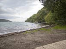 Baby girl whose body was found on Welsh shore may have been in water 'for a few weeks', police say