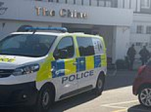 Armed police swarm to migrant hotel and make arrest after 'man attacked with a machete'
