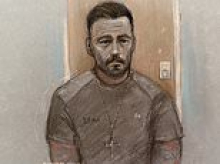Anti-migrant activist 'Danny Tommo' wears rosary beads as he appears in court charged with entering restricted zone at Dover migrant processing centre